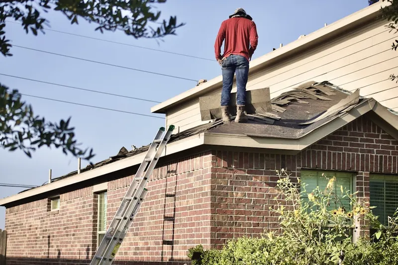 Professional roofer working on a residential roof in Neely Commons